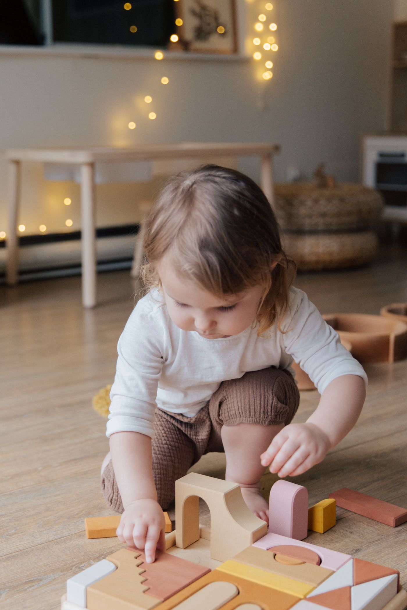 A toddler exploring wooden blocks through hands-on play